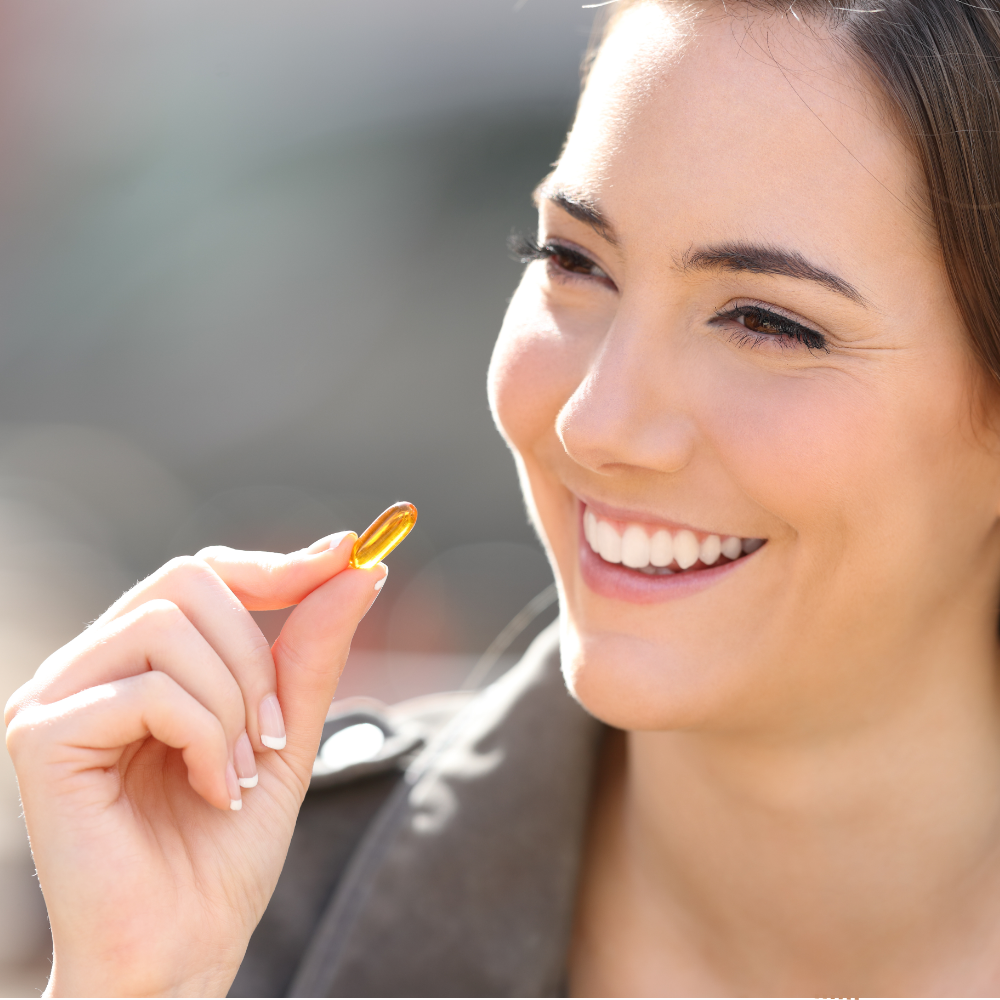 woman taking omega-3 supplement